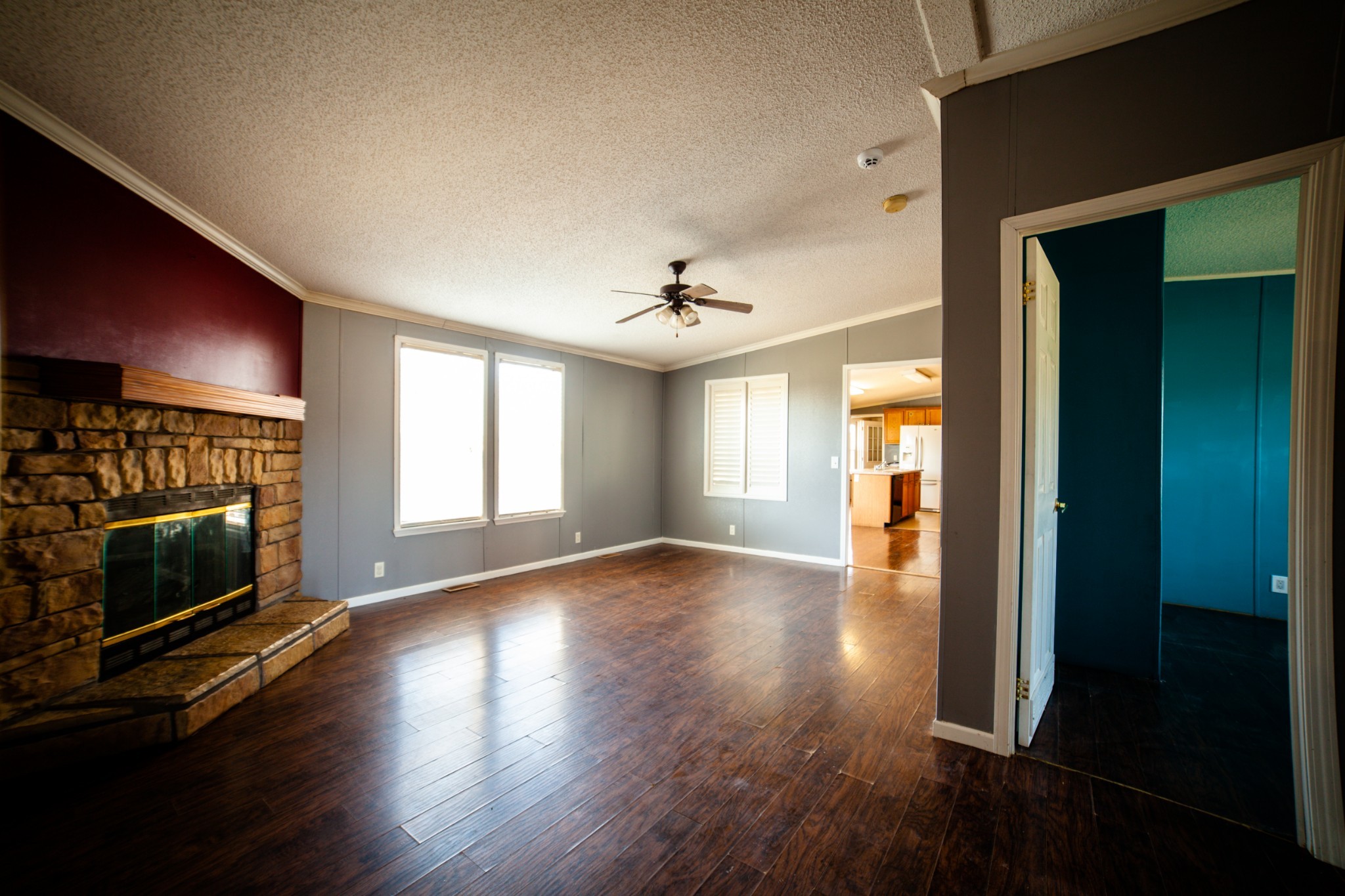 1606 Harpo Road Manchester, TN 37355 - Photo 13 of 27 an empty room with wooden floor fireplace and windows