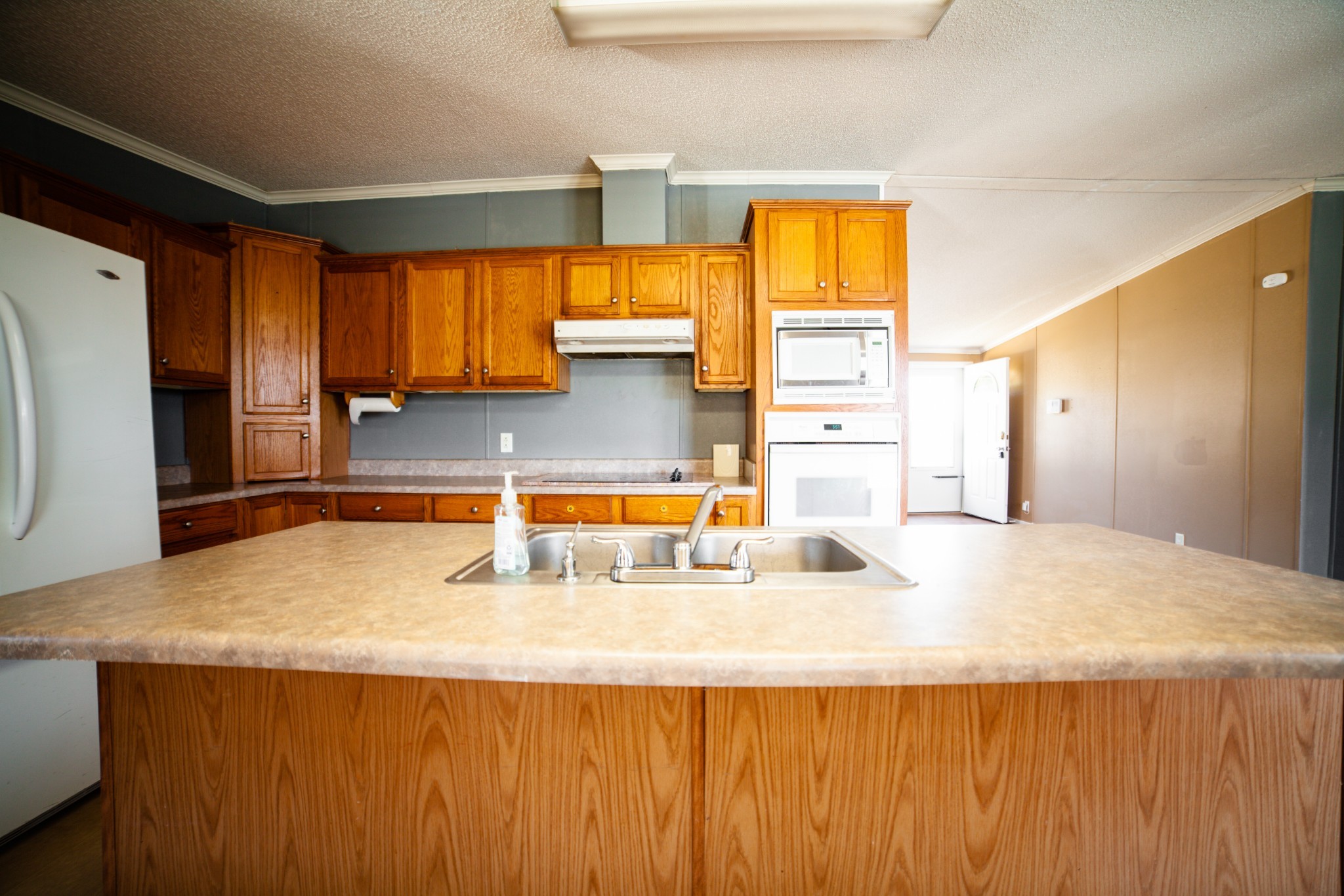 1606 Harpo Road Manchester, TN 37355 - Photo 17 of 27 a kitchen with a sink a counter top space and cabinets
