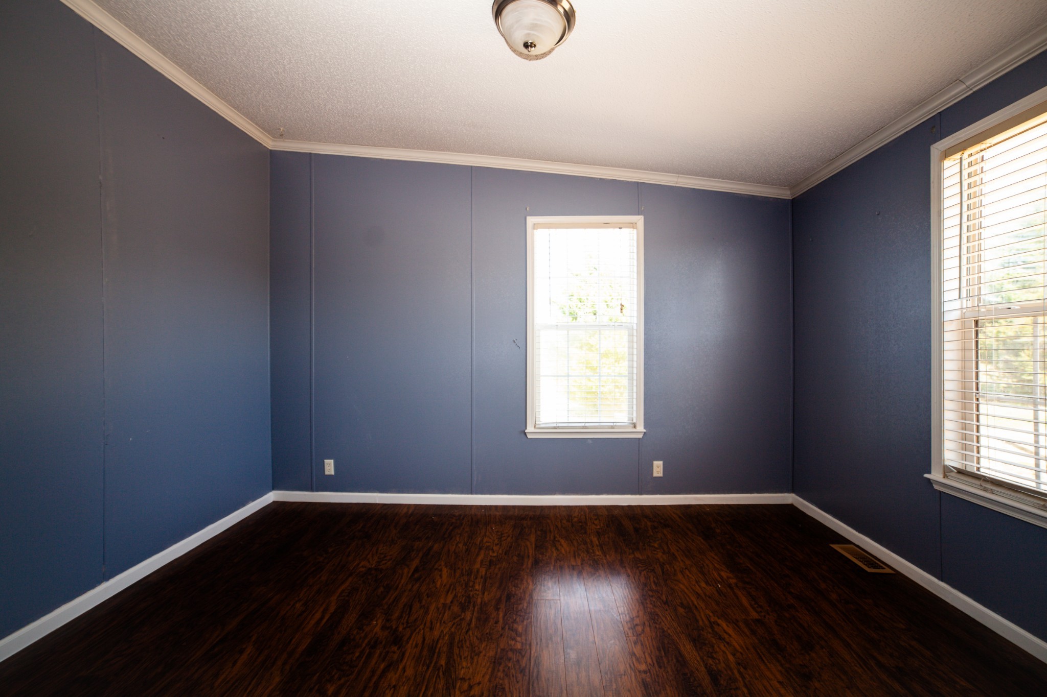 1606 Harpo Road Manchester, TN 37355 - Photo 22 of 27 a view of an empty room with wooden floor and a window
