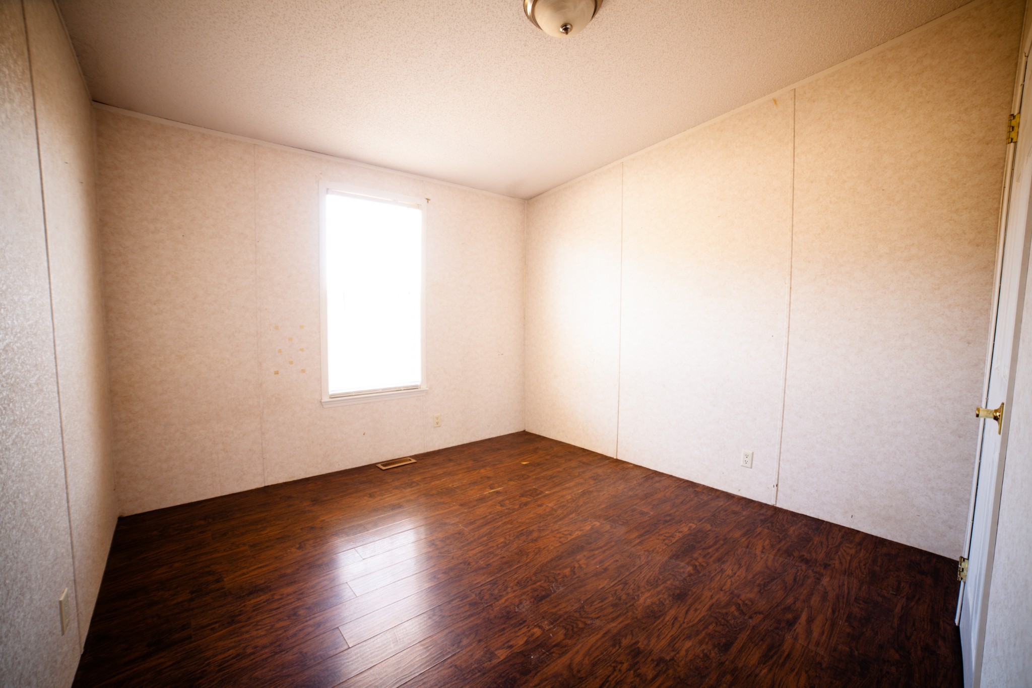 1606 Harpo Road Manchester, TN 37355 - Photo 8 of 27 an empty room with wooden floor and windows