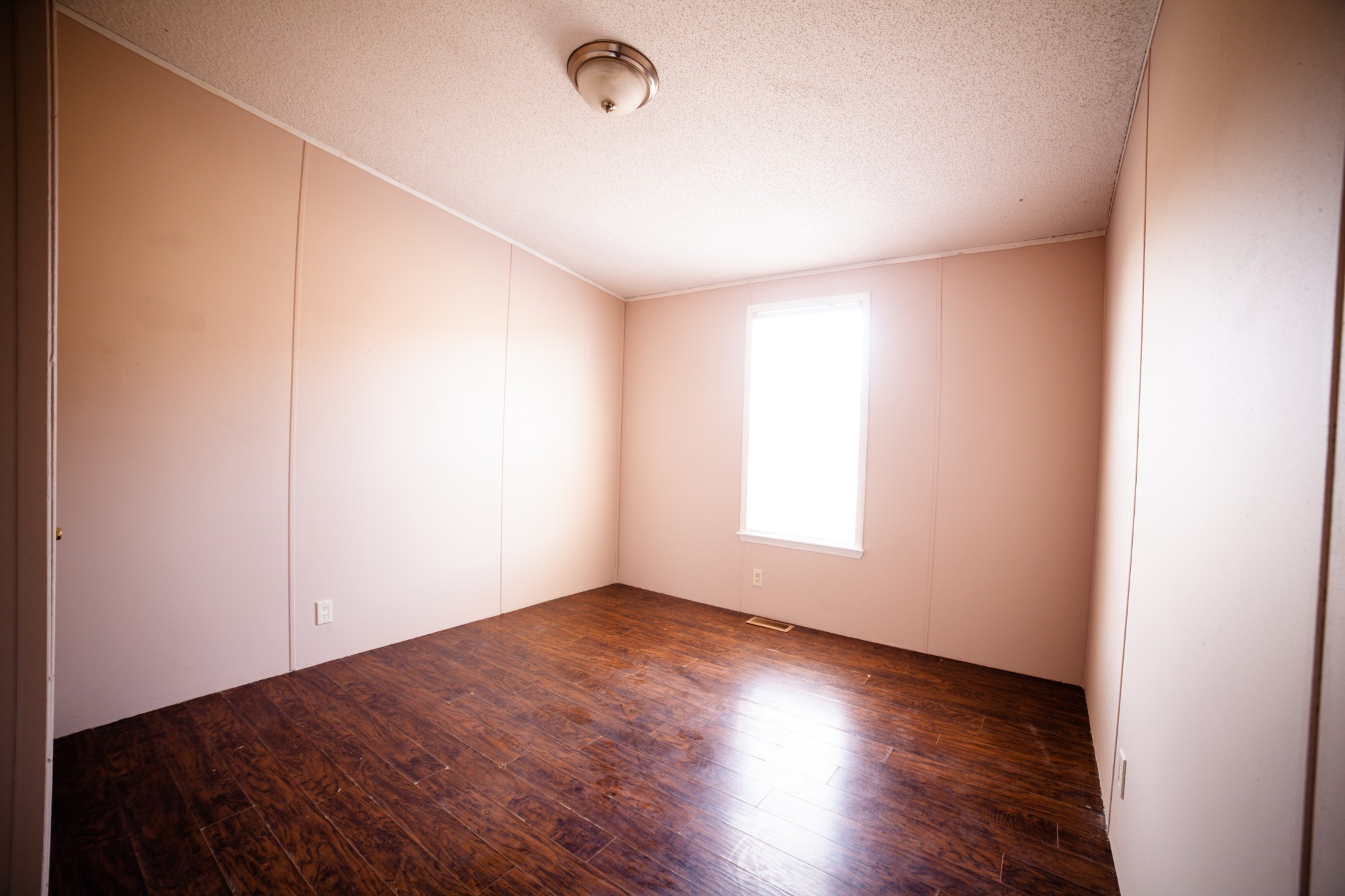 1606 Harpo Road Manchester, TN 37355 - Photo 9 of 27 an empty room with wooden floor and windows