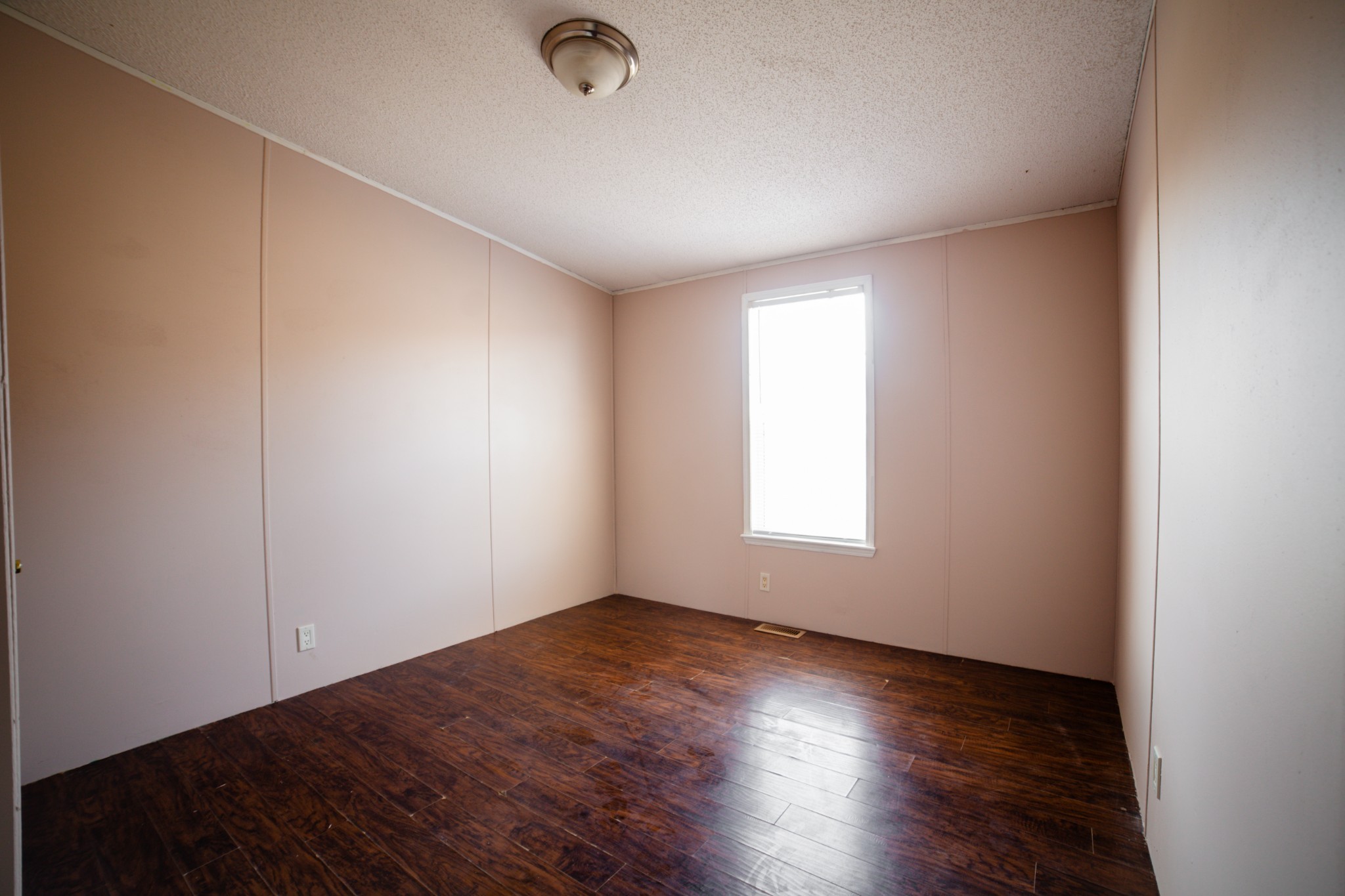1606 Harpo Road Manchester, TN 37355 - Photo 10 of 27 an empty room with wooden floor and windows