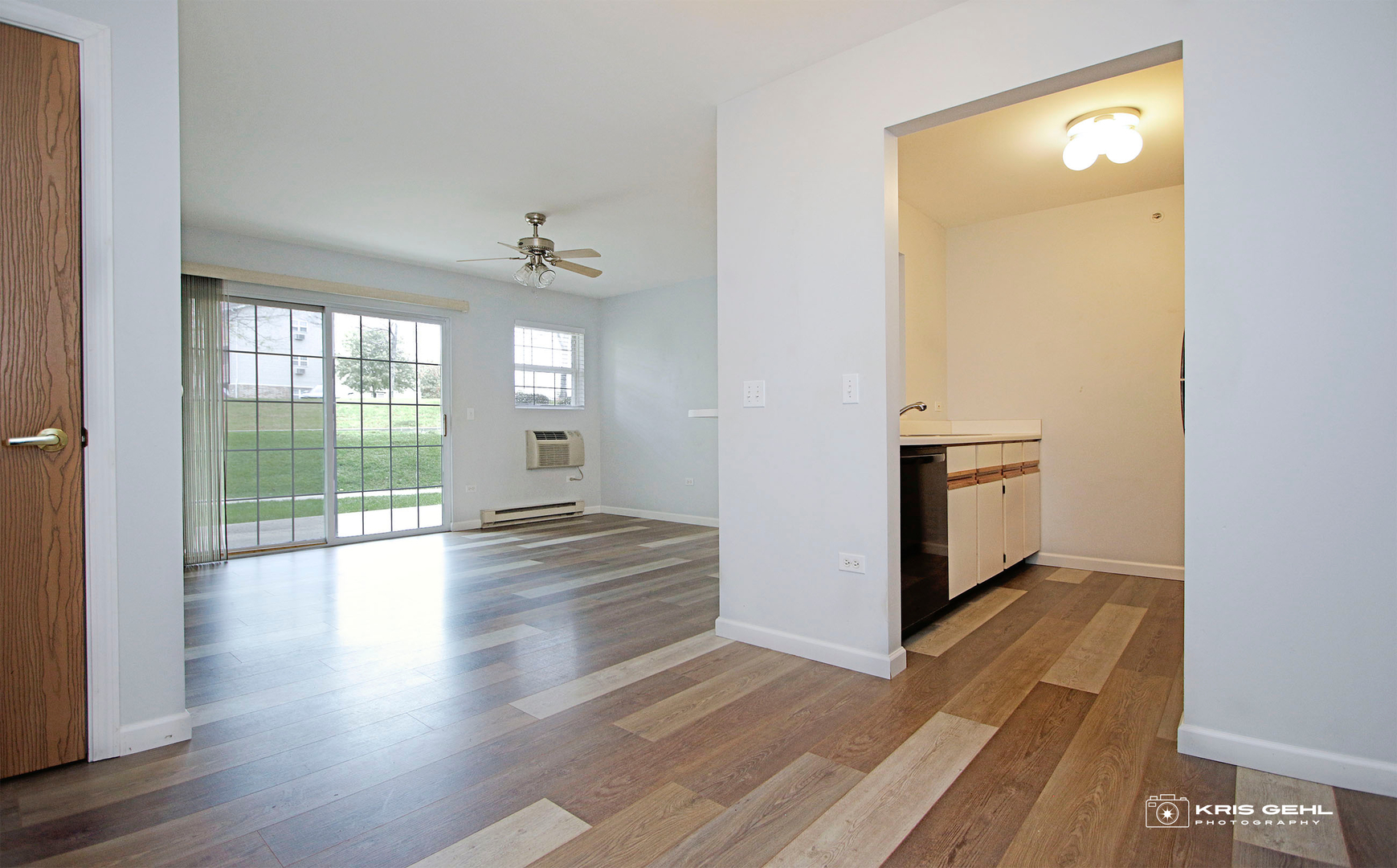 1551 Crystal Rock Court, Unit 1D Round Lake Beach, IL 60073 - Photo 3 of 16 a view of empty room with wooden floor and fan