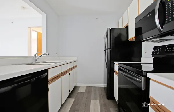 a kitchen with stainless steel appliances a sink and a refrigerator