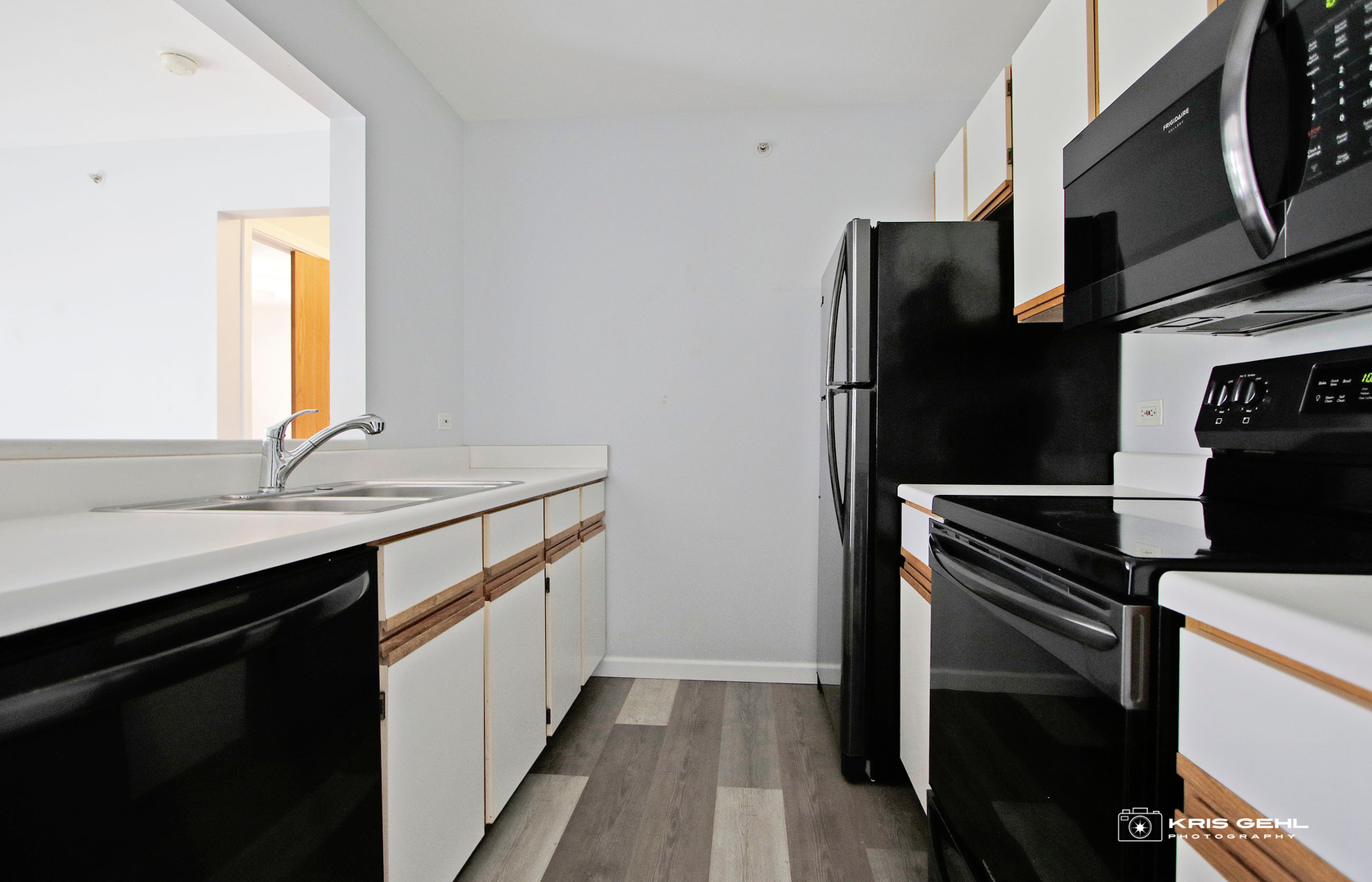 1551 Crystal Rock Court, Unit 1D Round Lake Beach, IL 60073 - Photo 4 of 16 a kitchen with stainless steel appliances a sink and a refrigerator
