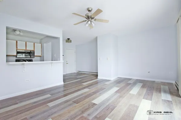 a view of kitchen with granite countertop cabinets and wooden floor
