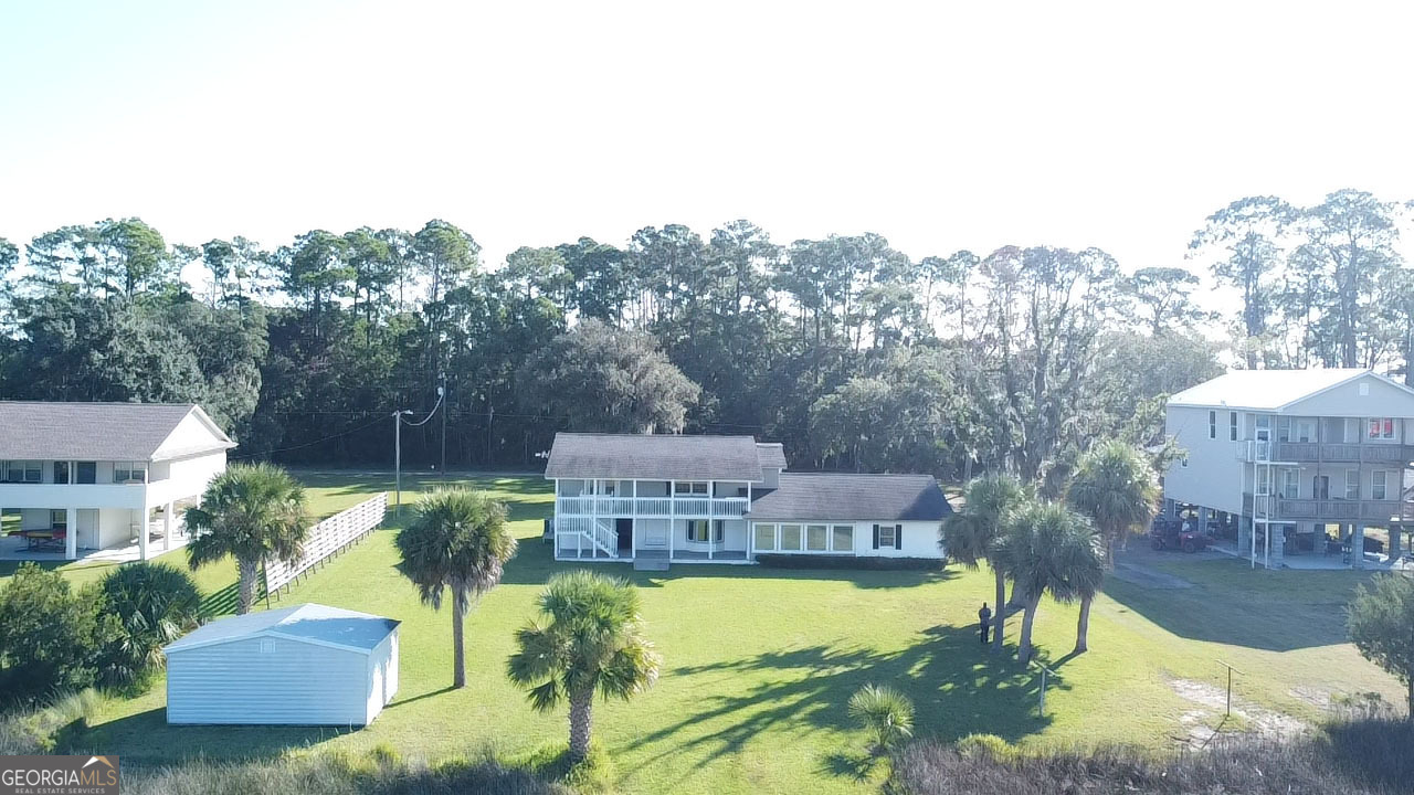 743 Cattle Hammock Road Midway, GA 31320 - Photo 11 of 63 an aerial view of a house with swimming pool garden and patio