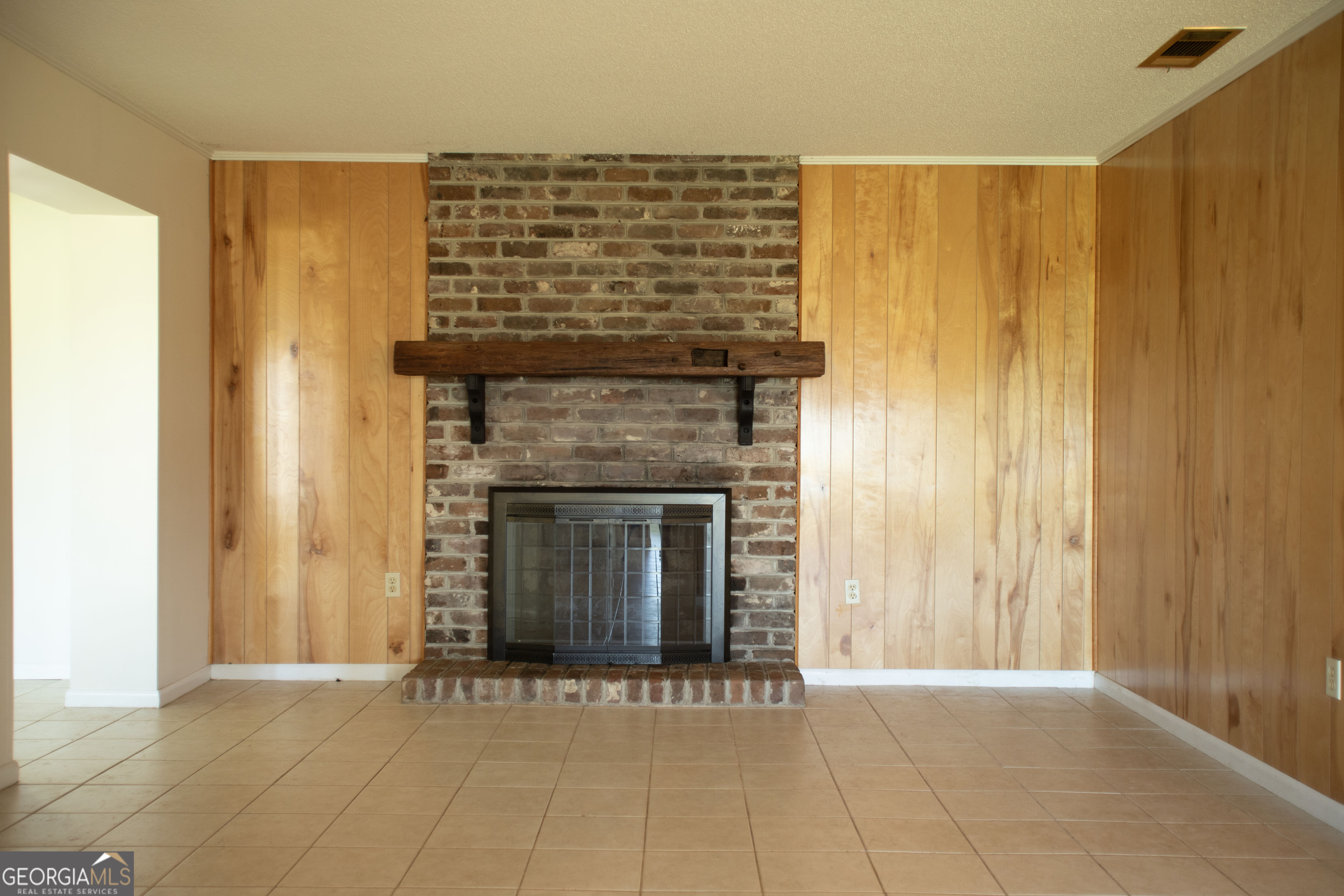 743 Cattle Hammock Road Midway, GA 31320 - Photo 18 of 63 a view of an empty room with wooden floor and a fireplace