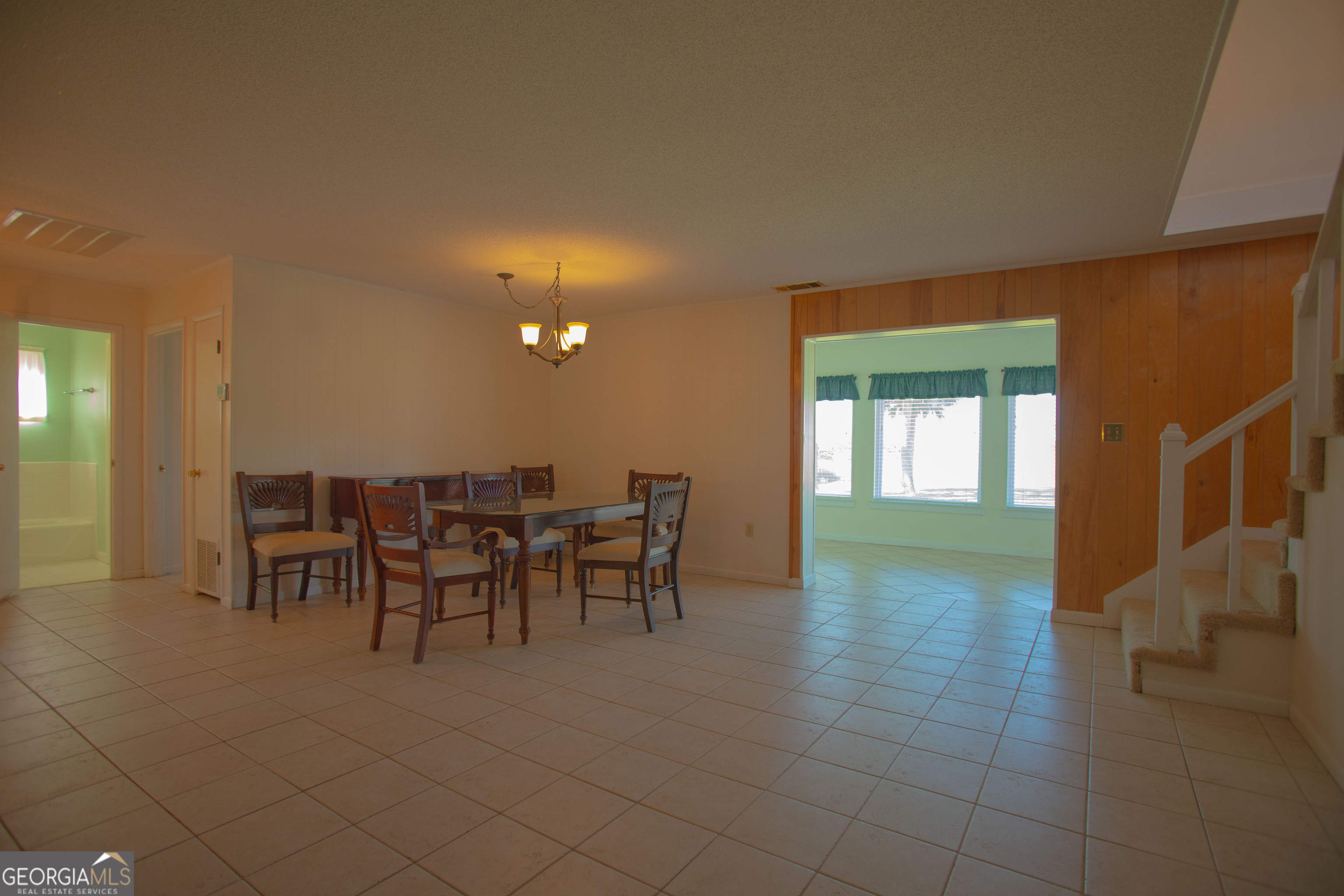 743 Cattle Hammock Road Midway, GA 31320 - Photo 19 of 63 a dining room with furniture and a chandelier
