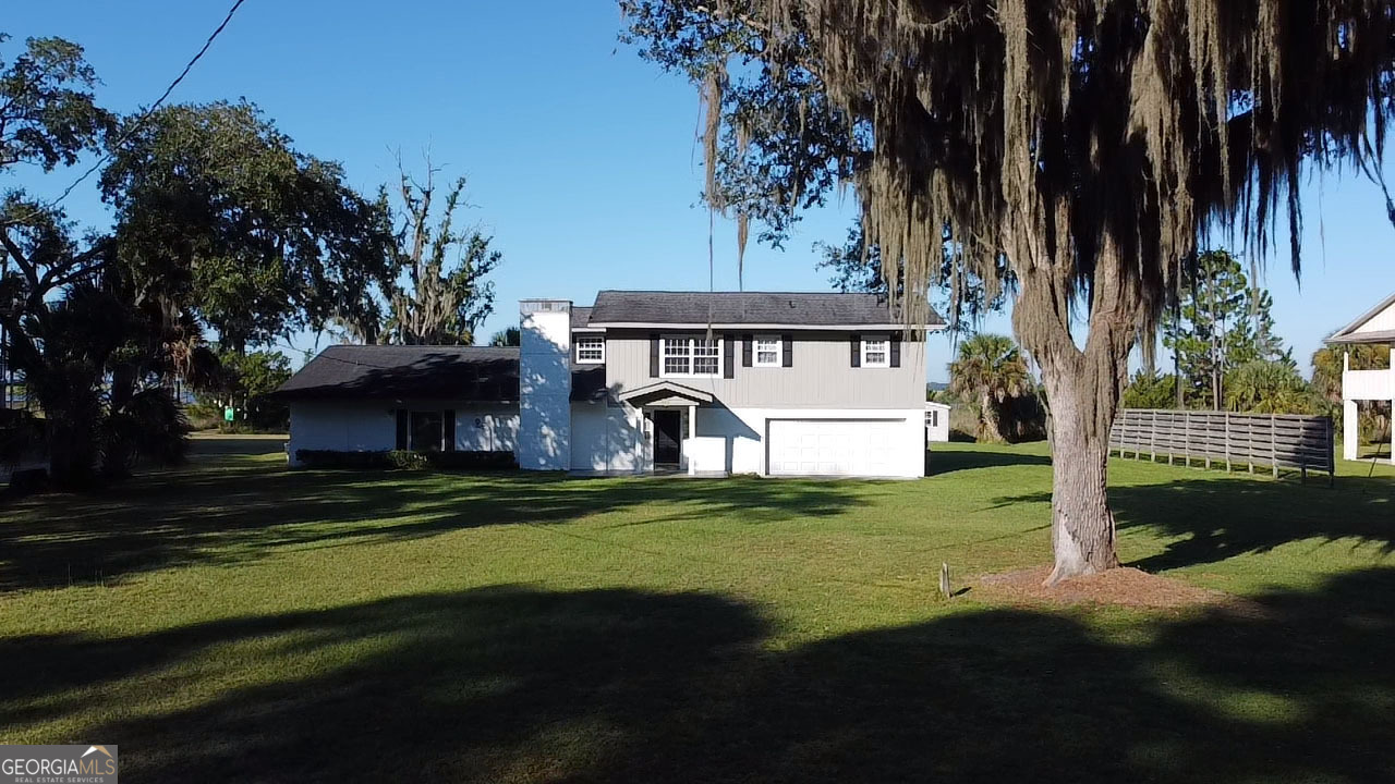 743 Cattle Hammock Road Midway, GA 31320 - Photo 2 of 63 a view of a house with a garden