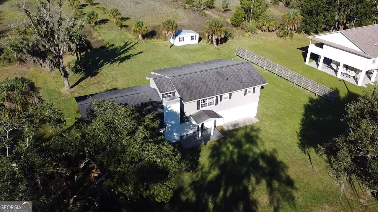 743 Cattle Hammock Road Midway, GA 31320 - Photo 3 of 63 an aerial view of a house with a yard basket ball court and outdoor seating