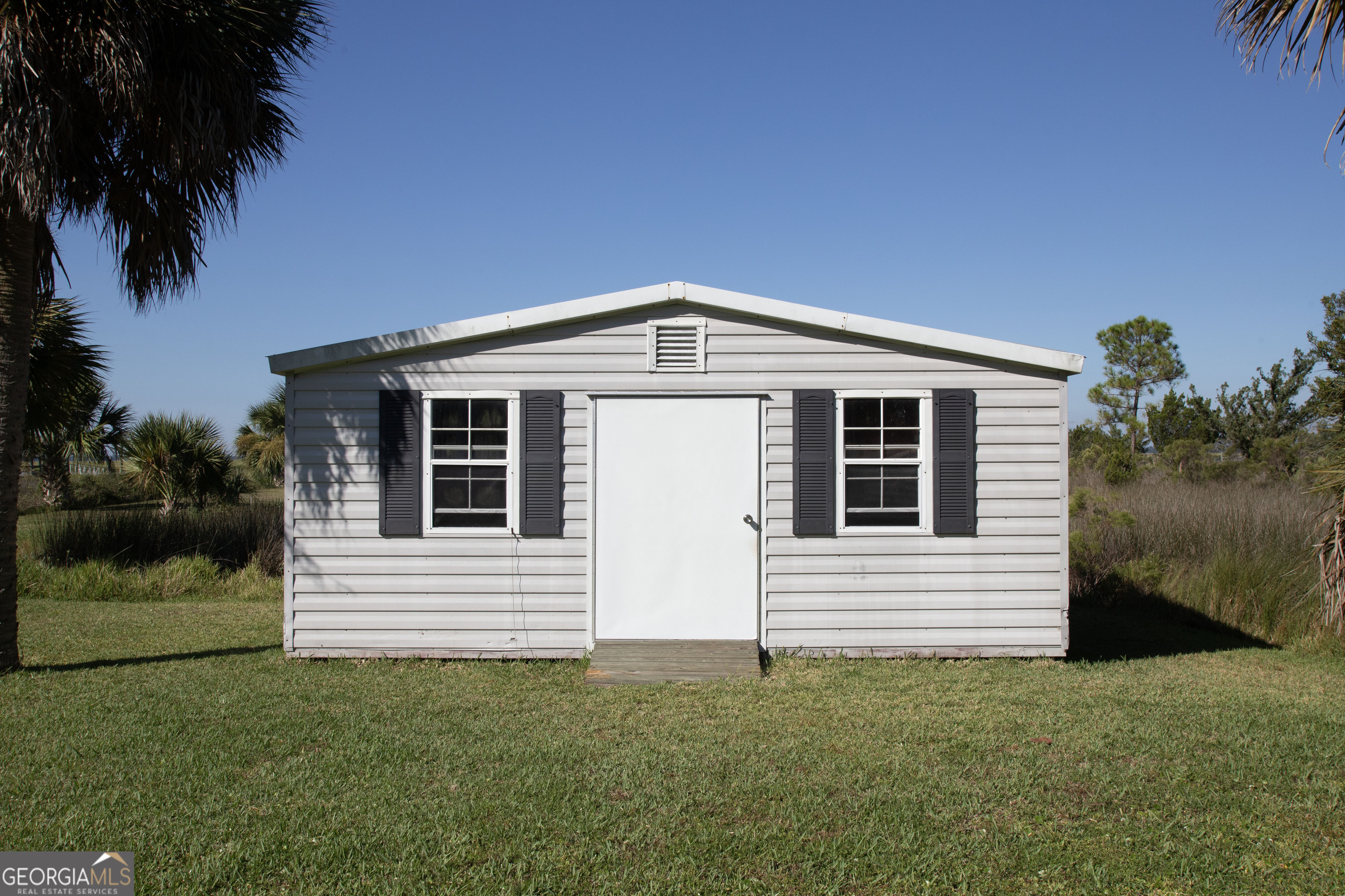 743 Cattle Hammock Road Midway, GA 31320 - Photo 38 of 63 a front view of a house with a garden