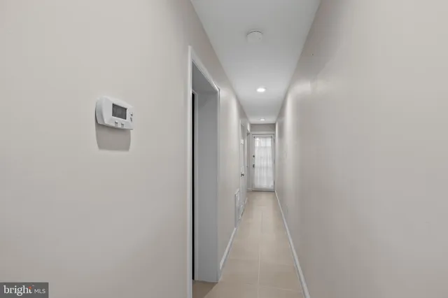 a view of hallway with stairs and wooden floor