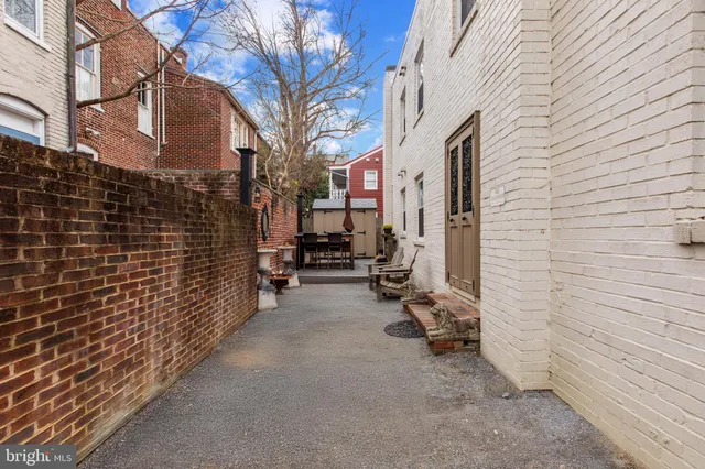 a backyard of a house with barbeque oven and a stove