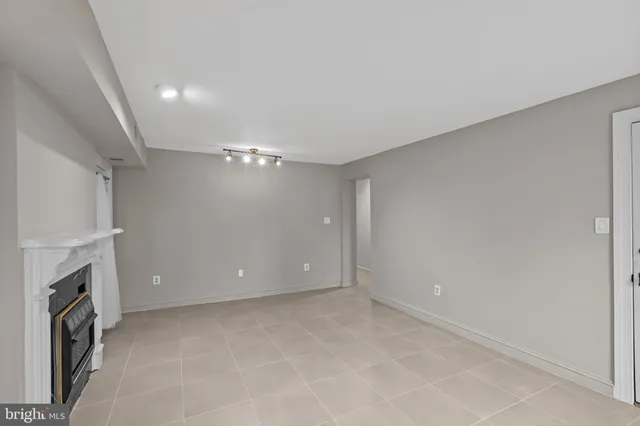 a view of empty room with a fireplace