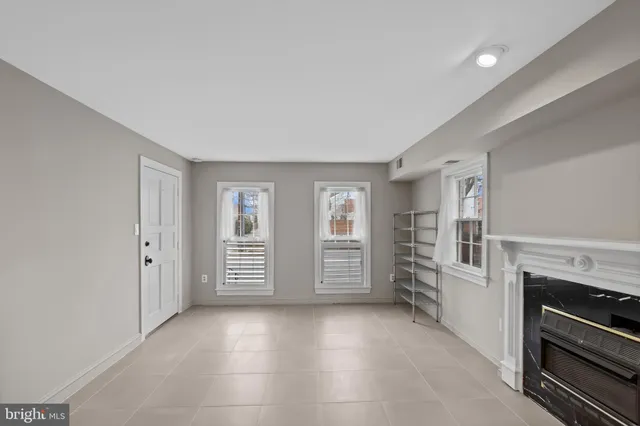 a view of an empty room with a fireplace