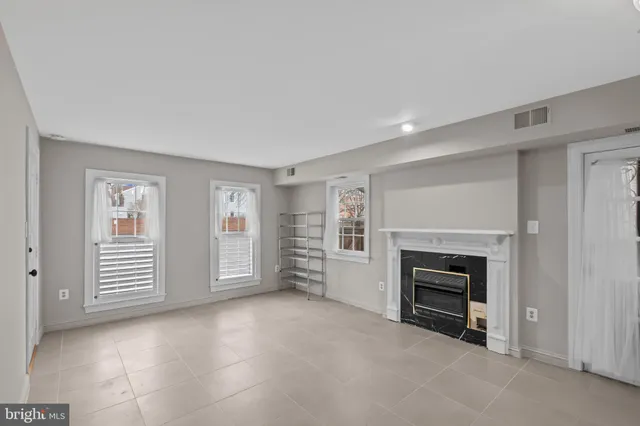 an empty room with furniture and a fireplace