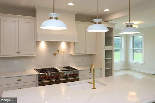 a kitchen with a stove and a chandelier