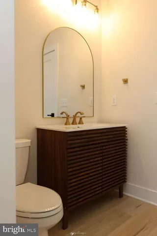 a bathroom with a sink a toilet and a mirror