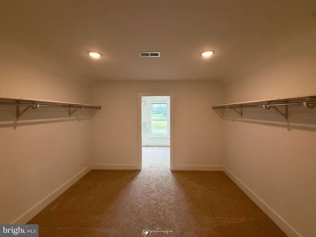 a bathroom with double vanity and a mirror