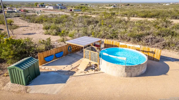 a view of a swimming pool with a yard