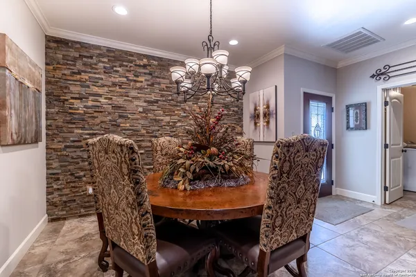 a view of a dining room with furniture and chandelier
