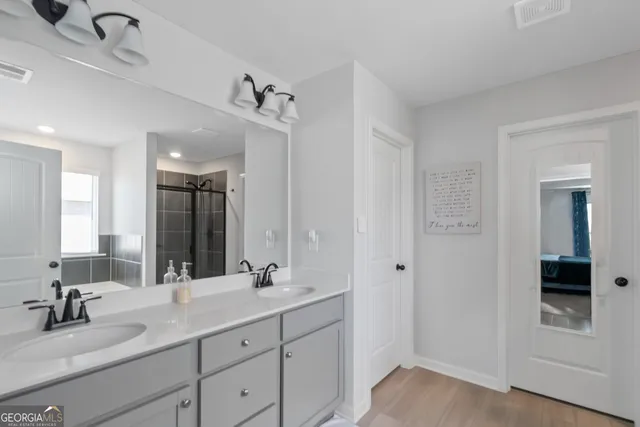 a bathroom with a tub a sink and mirror