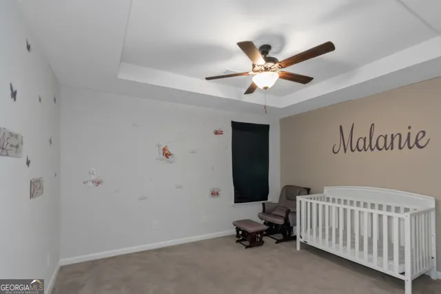 a room with furniture and ceiling fan