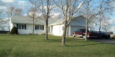 a view of a house with a backyard