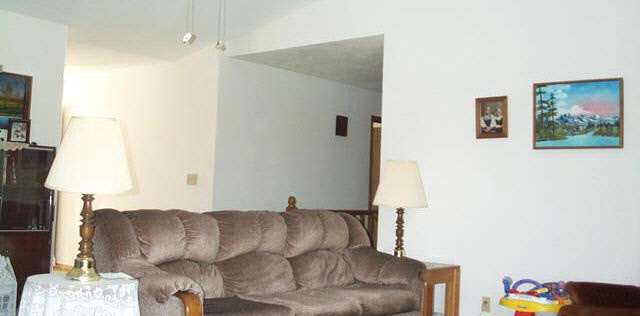 2596 Karr Road Belvidere, IL 61008 - Photo 2 of 6 a living room with furniture and a lamp
