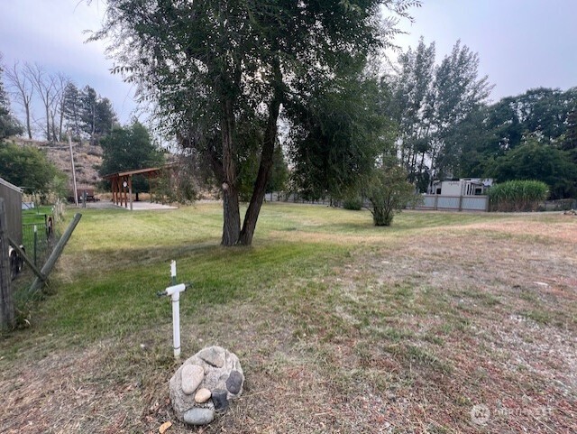 29 Twisp Airport Road Twisp, WA 98856 - Photo 7 of 19 a backyard of a house with table and chairs