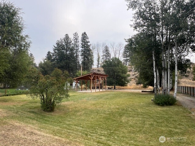 29 Twisp Airport Road Twisp, WA 98856 - Photo 10 of 19 a view of a town with large trees and a small barn