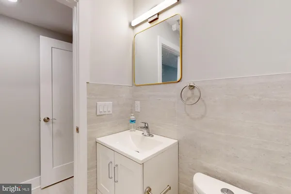 a bathroom with a sink a toilet and a mirror