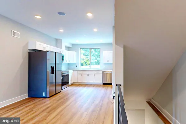 a kitchen with stainless steel appliances a refrigerator and a stove top oven