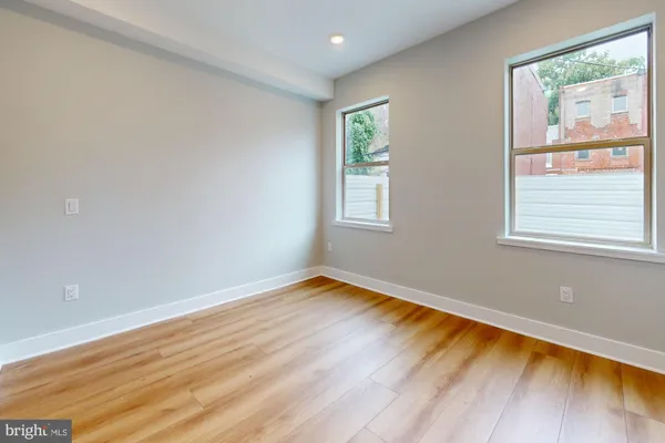 a view of room with window and wooden floor