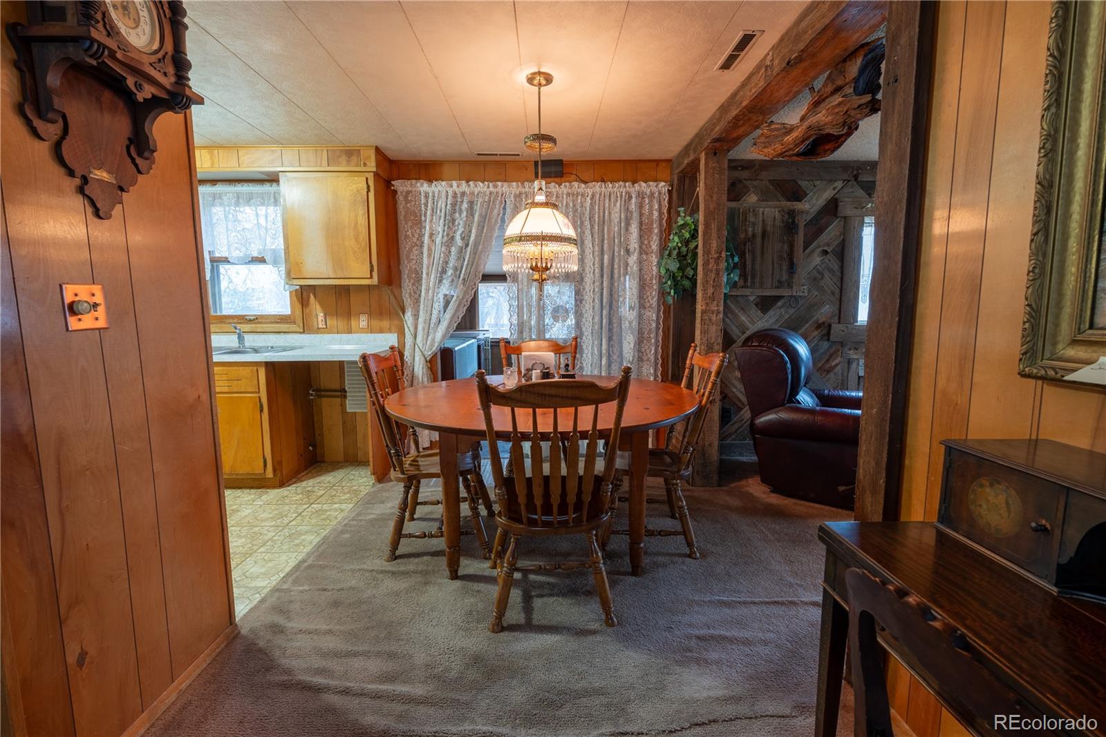 12169 East Baseline Road Lafayette, CO 80026 - Photo 10 of 39 a dining room with furniture window and wooden floor