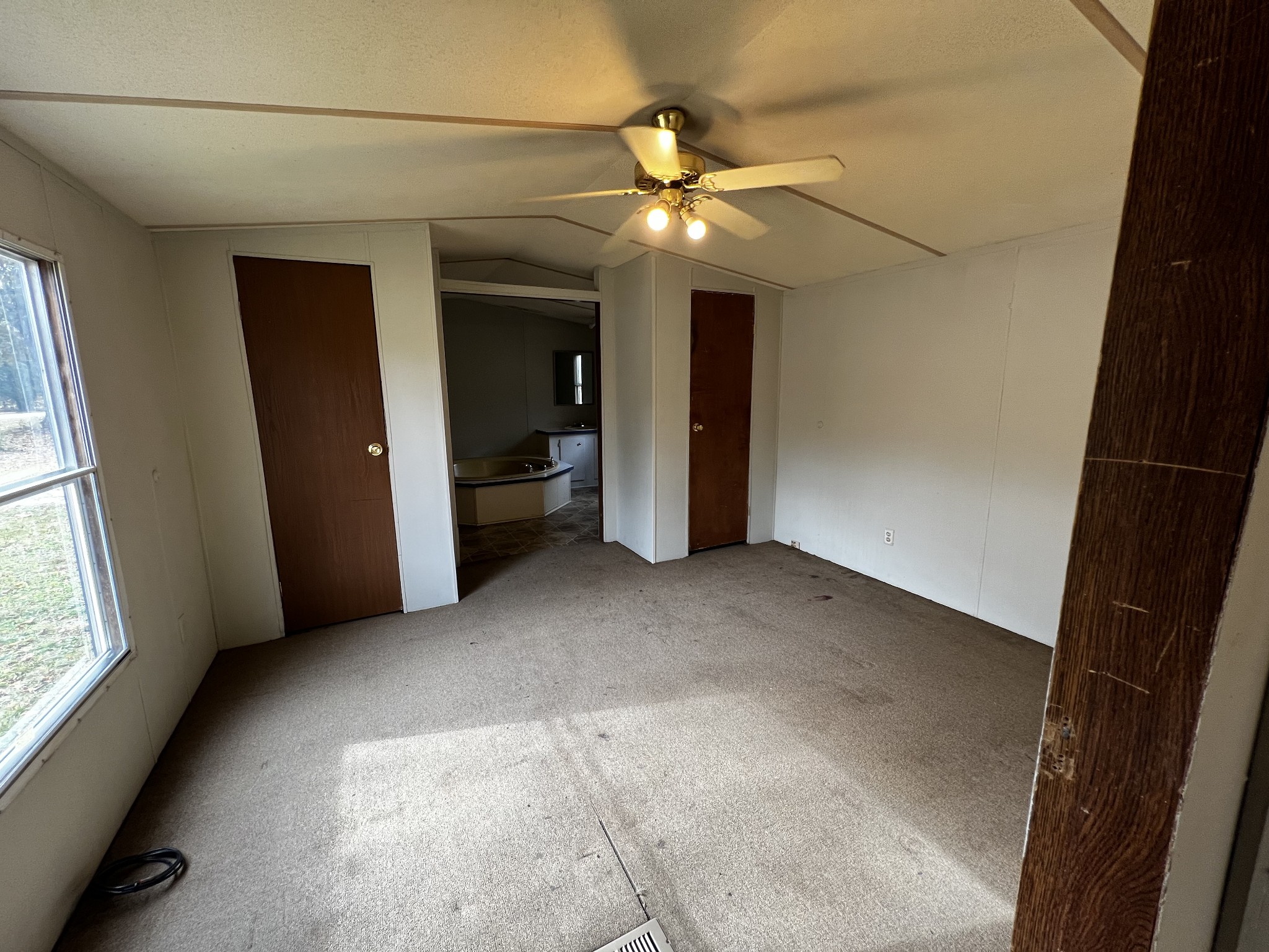 1244 Taylor Road Manchester, TN 37355 - Photo 8 of 14 a view of a livingroom with a ceiling fan and window