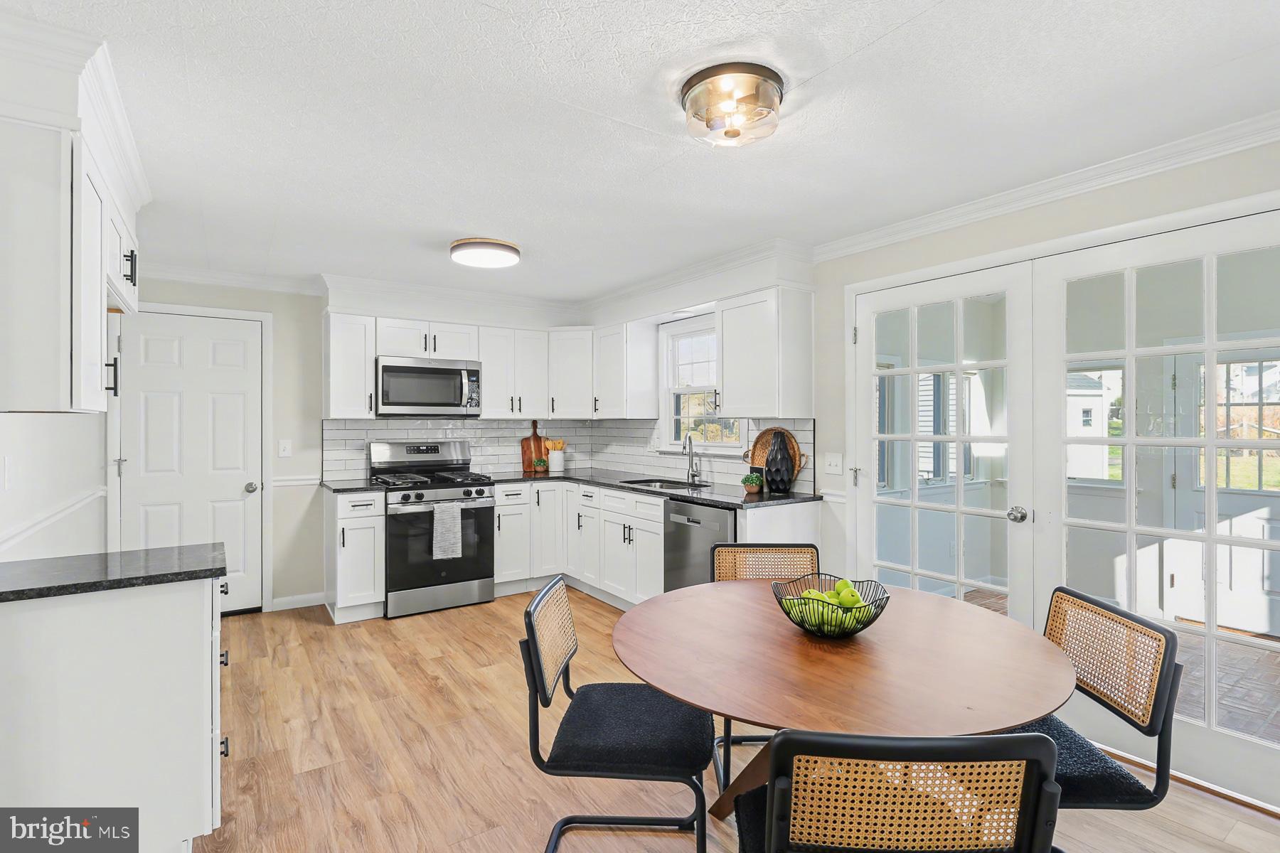 233 Cardinal Road Lititz, PA 17543 - Photo 8 of 26 a kitchen with refrigerator cabinets dining table and chairs