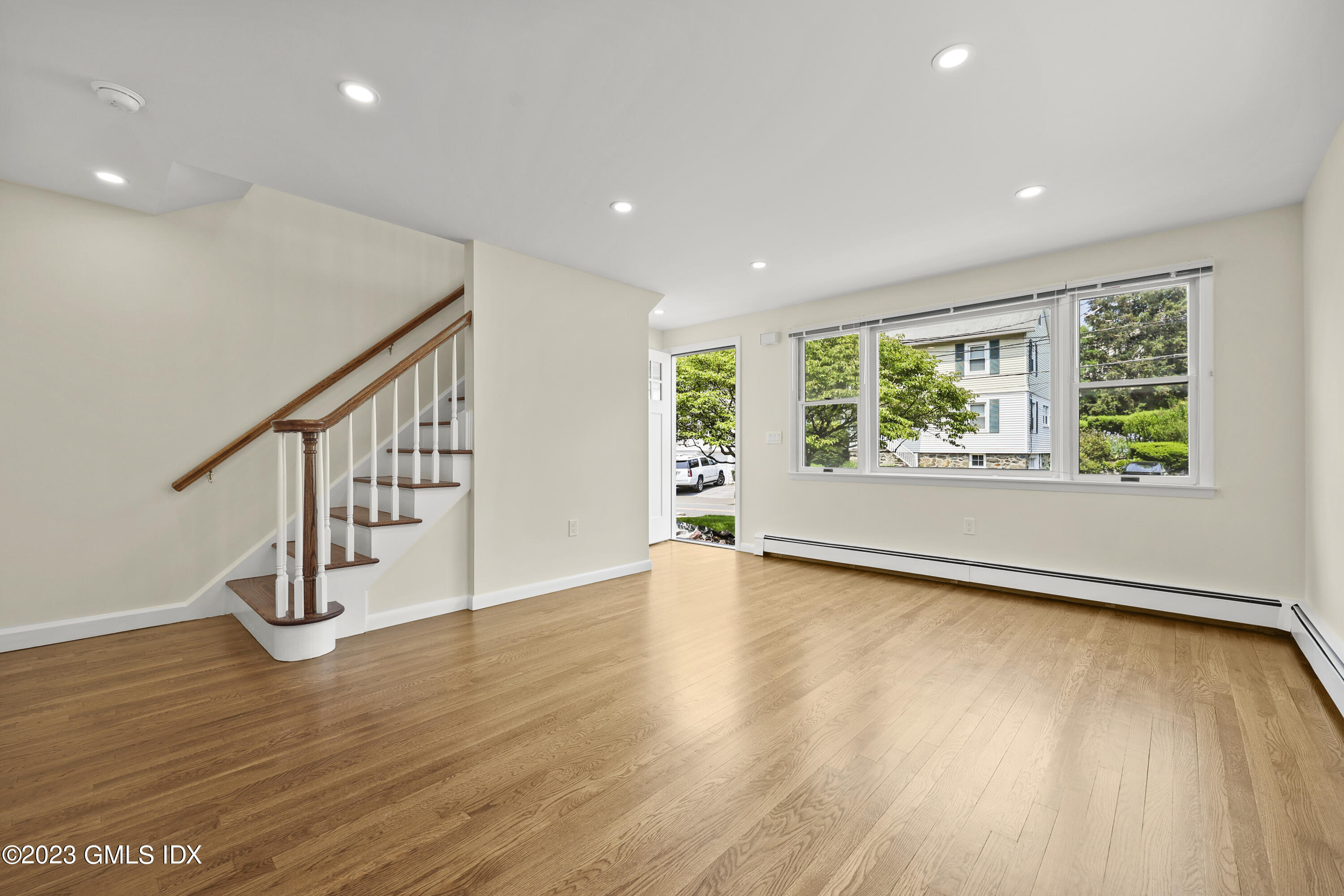 248 Byram Road, Unit L Greenwich, CT 06830 - Photo 2 of 14 a view of an empty room with wooden floor and a window