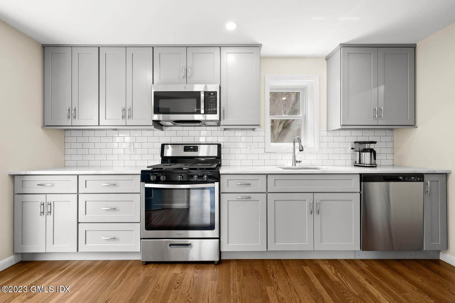 248 Byram Road, Unit L Greenwich, CT 06830 - Photo 4 of 14 a kitchen with stainless steel appliances granite countertop a stove a sink and a microwave