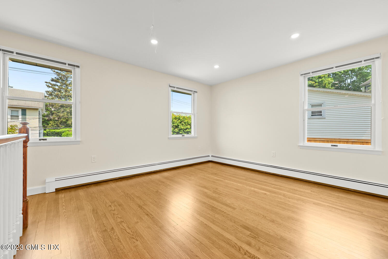 248 Byram Road, Unit L Greenwich, CT 06830 - Photo 7 of 14 wooden floor in an empty room with a window