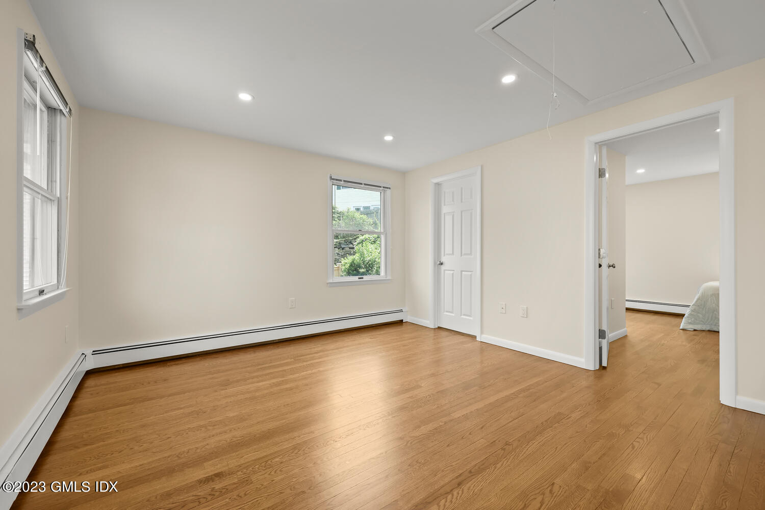 248 Byram Road, Unit L Greenwich, CT 06830 - Photo 8 of 14 an empty room with wooden floor and windows