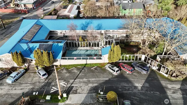 a kitchen with stainless steel appliances a refrigerator and wooden floor