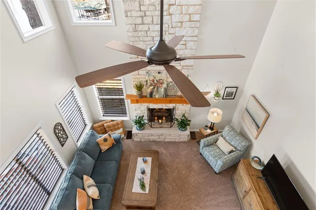 a living room with furniture a fireplace and a chandelier