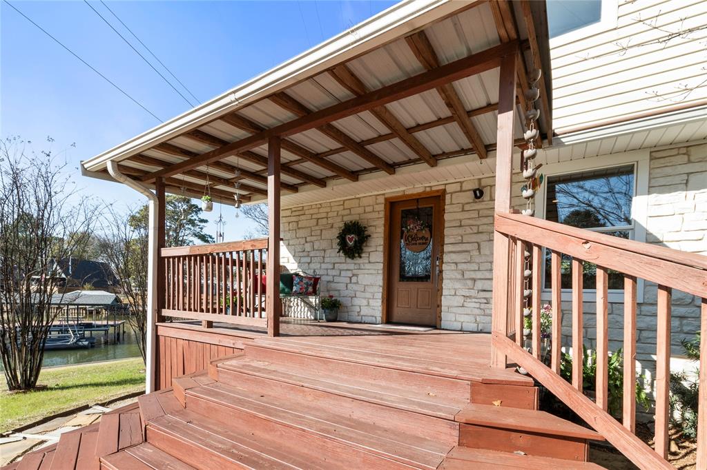 313 Sundown Trail Tool, TX 75143 - Photo 5 of 39 a view of a porch with wooden floor and iron stairs