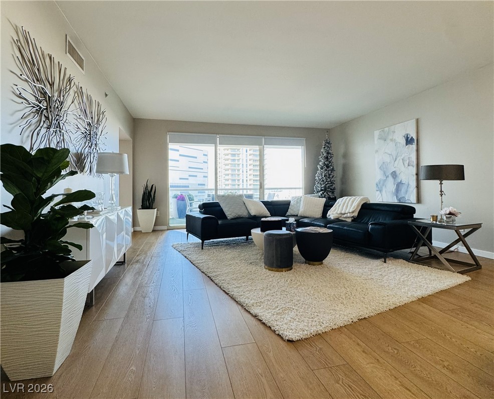 2857 Paradise Road, Unit 904 Las Vegas, NV 89109 - Photo 3 of 27 Living room featuring light wood-type flooring