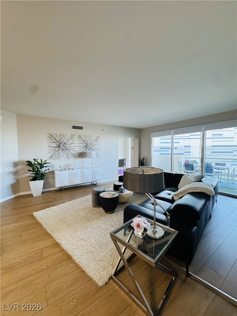 2857 Paradise Road, Unit 904 Las Vegas, NV 89109 - Photo 4 of 27 Living room featuring light wood-style floors and baseboards