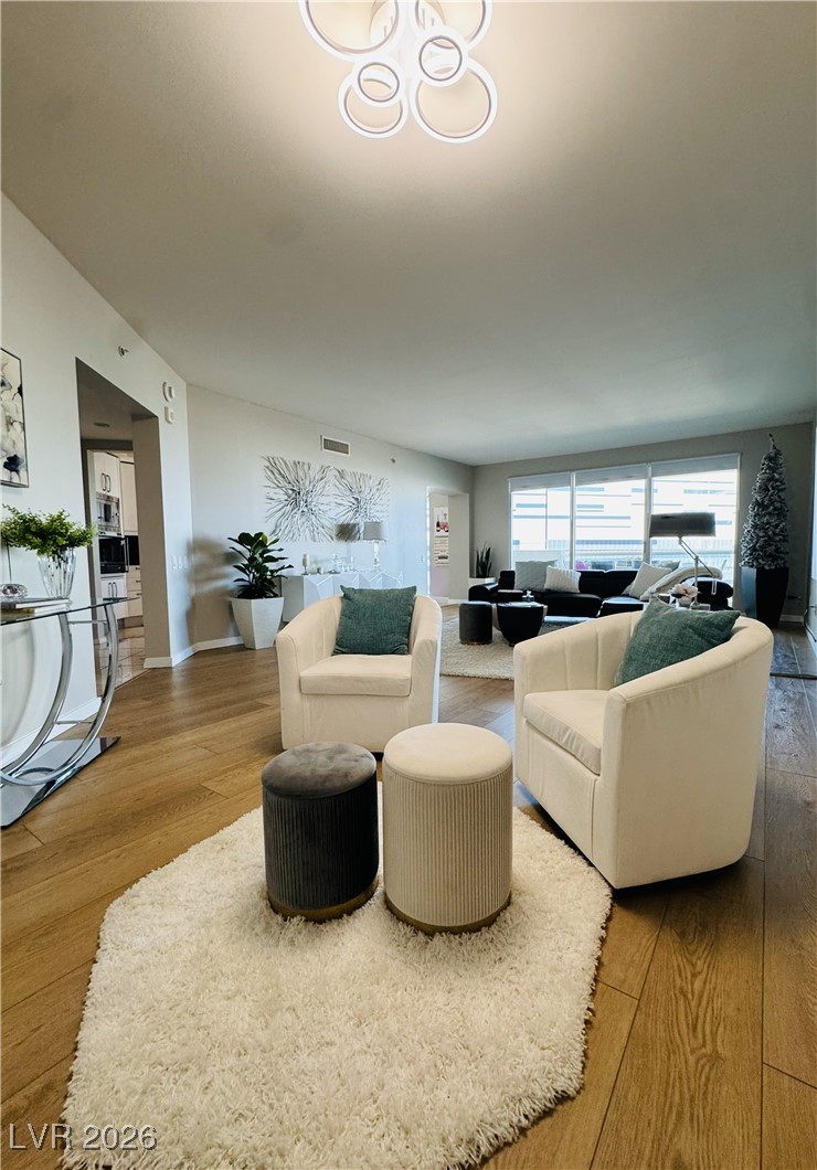 2857 Paradise Road, Unit 904 Las Vegas, NV 89109 - Photo 5 of 27 Living room featuring wood-type flooring and baseboards