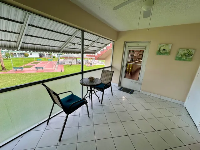 a view of chairs and table in a room