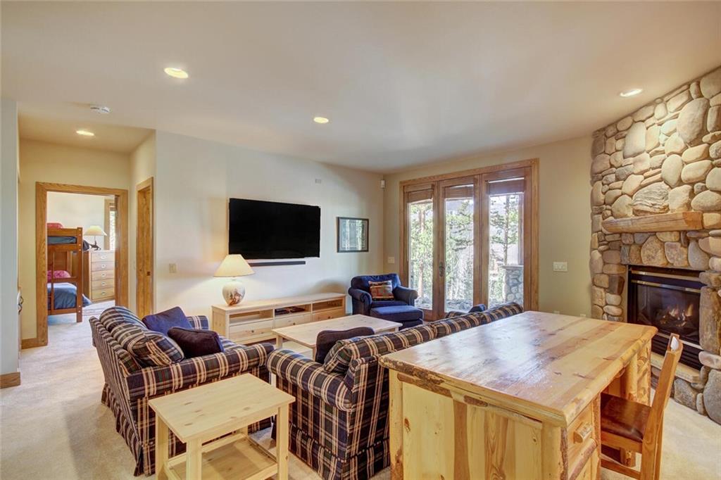 265 Mountain Bluebell Road Keystone, CO 80435 - Photo 13 of 35 a living room with furniture a flat screen tv and a fireplace